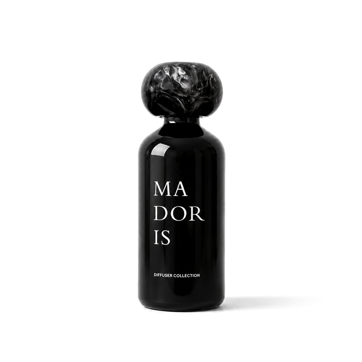 MADORIS Dark Citrus reed diffuser with black sculptural cap and black glass bottle