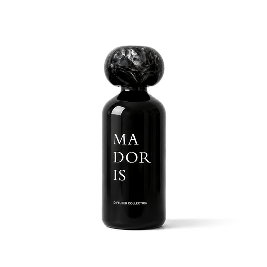 MADORIS Dark Citrus reed diffuser with black sculptural cap and black glass bottle
