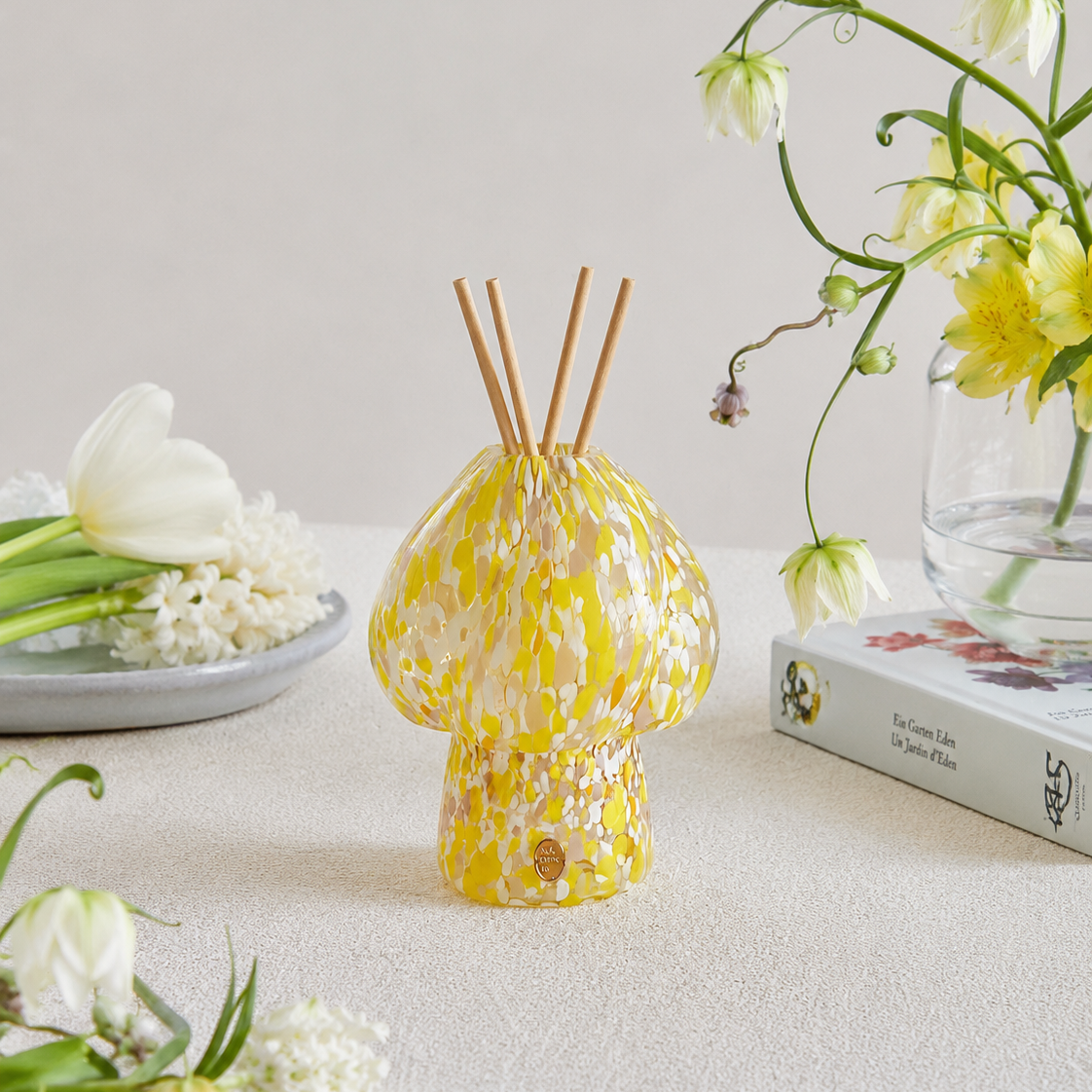 MADORIS Golden Hour reed diffuser styled in a bright interior with fresh botanical details