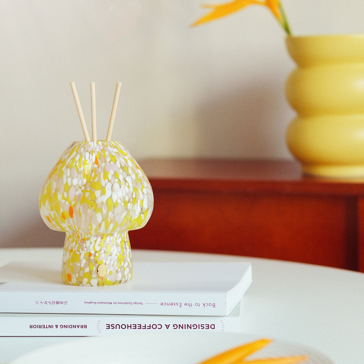 MADORIS Golden Hour reed diffuser displayed in a warm modern interior with sculptural decor