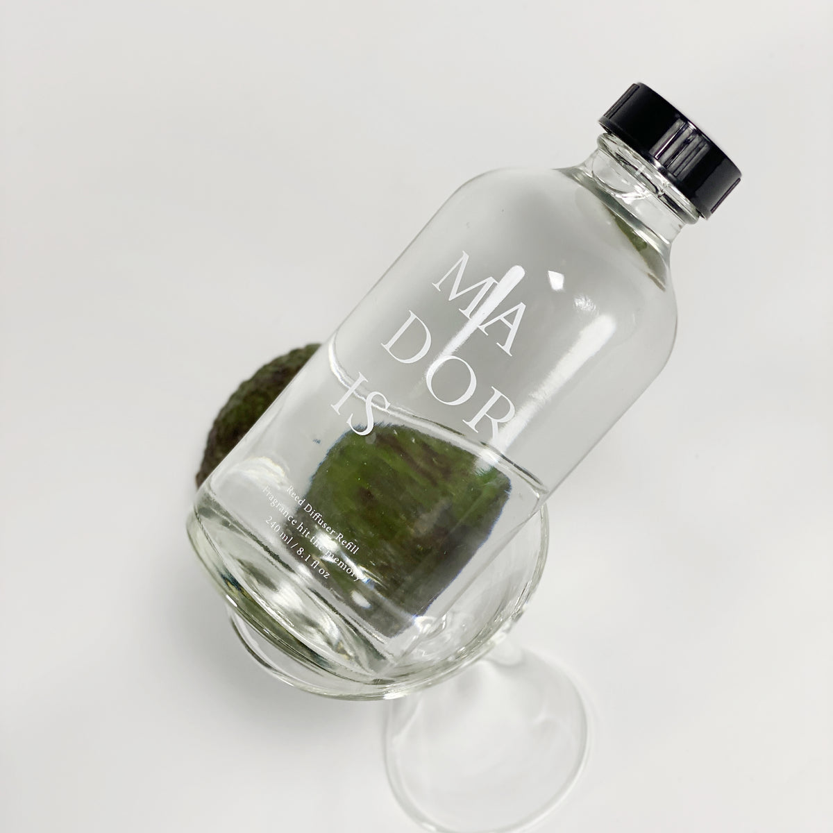 MADORIS Golden Hour 240ml fragrance refill styled in a minimal botanical setting
