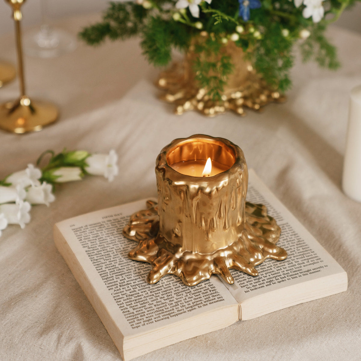 MADORIS Molten Bloom scented candle styled on a table in a warm elegant interior