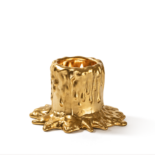 MADORIS Molten Bloom scented candle with sculptural gold wax vessel on a white background