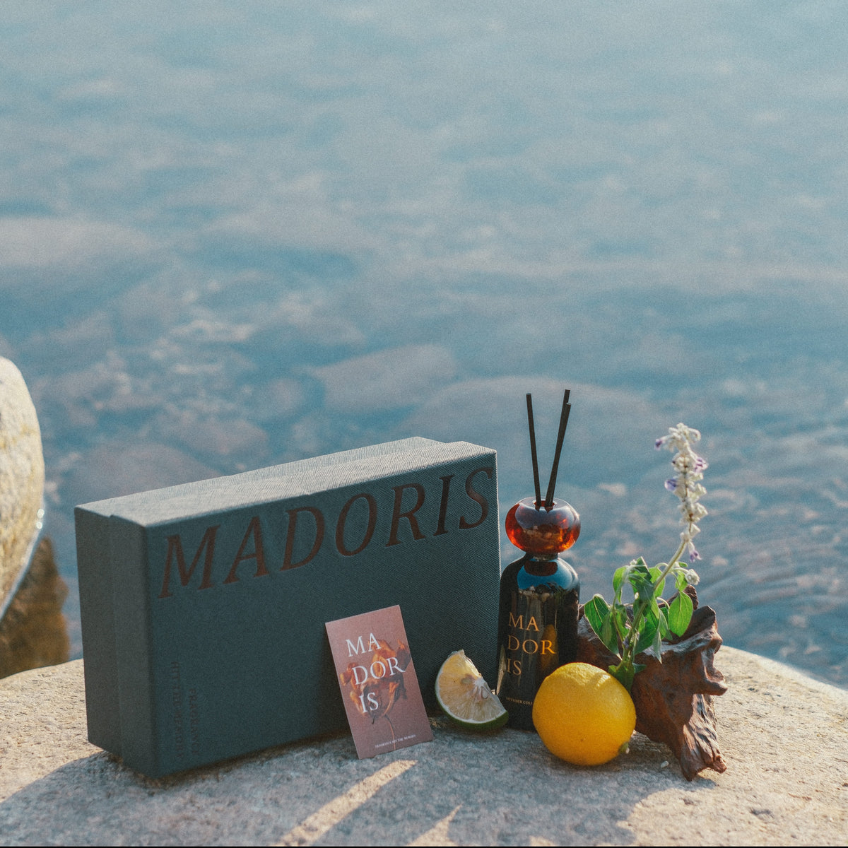 MADORIS Moonlight Glass reed diffuser with signature gift box in a coastal setting